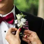 man wearing black notched-lapel suit jacket