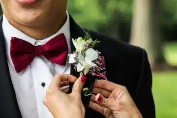 man wearing black notched-lapel suit jacket